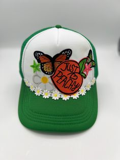 Just Peachy Trucker hat with butterflies, daisies, flowers and patches. Retro Trucker Hat With Curved Brim For Spring, Retro Curved Brim Trucker Hat For Spring, Retro Short Brim Trucker Hat For Spring, Retro Trucker Hat With Short Brim For Spring, Spring Multicolor Snapback Trucker Hat, Playful Spring Trucker Hat With Curved Brim, Vintage Green Trucker Hat For Summer, White Patches Hat For Summer, Vintage White Trucker Hat For Spring