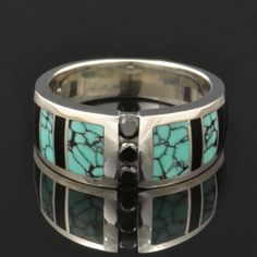 "Spiderweb turquoise ring with black onyx and black diamond accents designed by Mark Hileman. This woman's handmade band features 3 channel set round black diamonds flanked by alternating black onyx and spiderweb turquoise inlay. The 3 black diamonds weigh a total of .18 carats. The ring is 8.5mm wide at the widest point and will be made to order in your size in 3 to 6 weeks. This band is available in other color combinations and in 14k gold or stainless steel for an additional charge. It is han Multi-stone Diamond Jewelry With Round Stones, Luxury Jewelry With Multi-stone Round Shape, Luxury Multi-stone Round Jewelry, Modern Channel Set White Gold Jewelry, Modern Jewelry With Channel Set Round Band, Fine Jewelry With Inlay For Anniversary, Luxury Three-stone Ring Jewelry, Luxury Turquoise Ring Jewelry, Luxury Silver Jewelry With Inlay