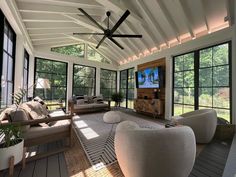 a living room filled with furniture and lots of windows