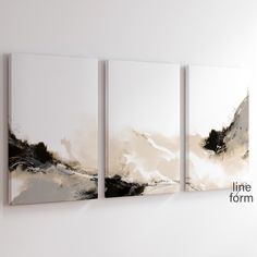 three abstract paintings hanging on the wall