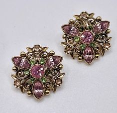 Add a touch of vintage glamour to your outfit with these beautiful Avon pierced earrings. The earrings feature a stunning combination of pink and green rhinestones that shimmer in the light. The earrings have an antiqued gold tone finish that gives them a retro and fashionable feel. *Hoping my love of antique vintage jewelry and accessories and the pieces I offer will make you smile and something will catch your eye!! My goal is to exceed your expectations! *Reasonable offers welcomed, if you LO Glamour Vintage, Antique Earrings, Vintage Avon, Vintage Glamour, Pierced Earrings, Earings Piercings, Jewelry Earrings Studs, Antique Vintage, Antique Gold