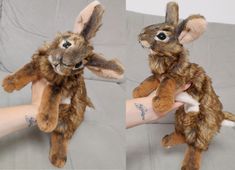 the stuffed animal rabbit is being held by someone's hand, both with tattoos on their arms