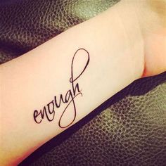 a tattoo with the word enough written in cursive writing on it's arm