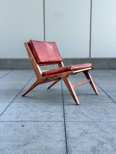 a wooden chair sitting on top of a tiled floor