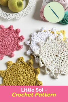 there are crocheted doily and yarns on the table