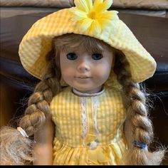 a doll wearing a yellow dress and hat