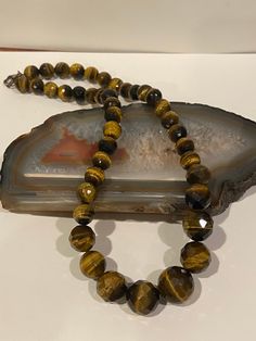 "This is a beautiful, vintage, genuine Tiger's Eye and sterling silver beaded necklace. The necklace measures about 18 inches. The round Tiger's Eye stones are vibrant and stunning. They measure 3/4\" in diameter for the largest one then tailor down to 5/8\", 1/2\" and 3/8\" in diameter. The necklace weighs a hefty 73.4 grams and is stamped 925. Perfect to wear on its own or add a large pendant. Very well-made and gorgeous! See picture for details. More gorgeous jewelry here, and some on BIG cle Vintage Polished Beads Round Necklace, Vintage Polished Beads Necklace, Vintage Round Polished Beads Necklace, Vintage Round Necklaces With Polished Beads, Vintage Faceted Beads Gems And Cabochons As A Gift, Vintage Faceted Beads For Gifts, Vintage Round Beaded Necklace Gift, Vintage Necklace With Faceted Beads For Gift, Vintage Polished Beads Necklace For Gift