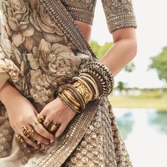 a close up of a woman's hands wearing bracelets