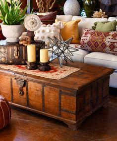 a living room filled with lots of furniture and decor on top of a wooden table