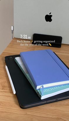 an ipad with a book on top of it