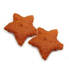 two star shaped crackers sitting next to each other on top of a white surface