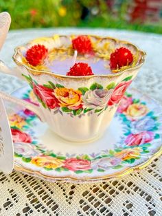 a tea cup and saucer with flowers on it