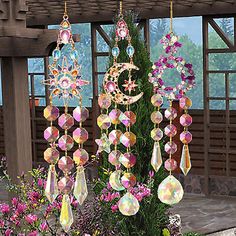 a potted plant filled with lots of different colored beads hanging from it's sides