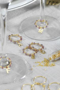 three wine glasses with gold jewelry on them