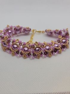 Beautiful and eye catching! This substantial bracelet warms quickly to your body temperature.  I'm going to call it lavender hue, and overall, that's the color you see, but so many colors come into play. Perfect for an evening out with friends or that special someone.  8mm lavender pearl beads 4mm dark purple czech bicone crystals 3mm white pearl beads 11/0 lavender seed beads 15/0 yellow gold seed beads Lobster clasp Extension chain Even though this bracelet is a bit longer, you need the extra Purple Beaded Bracelets For Wedding, Purple Beaded Bangle Bracelets For Party, Lavender Bracelets With Spacer Beads As Gift, Lavender Bracelets With Spacer Beads For Gift, Purple Beaded Bracelet Jewelry, Lavender Beaded Bracelet Jewelry, Elegant Purple Crystal Bracelet With Spacer Beads, Purple Beaded Pearl Bracelet As Gift, Handmade Purple Beaded Bangle Bracelet