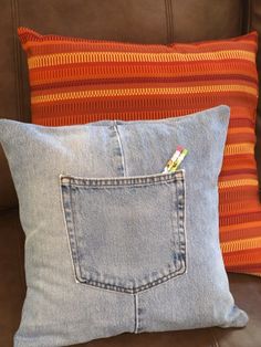 two pillows made out of old jeans on a couch