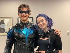 a man and woman dressed up as batman and catwoman posing for a photo together