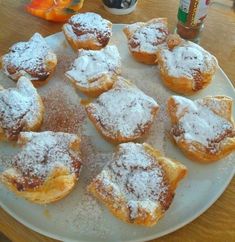 powdered sugar covered pastries on a white plate