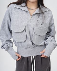 This grey zip-up sweatshirt features a cropped fit and big grey pockets in front. The very sweatshirt that Lisa from Blackpink wore in her special 27th Birthday vlog! To complete the outfit, also check out the purple socks with a cat design that Lisa wore in the video﻿ Size:• S: Bust: 102cm/ 40.1 in, Length: 51cm/ 20.0 in • M: Bust: 104cm/ 40.9 in, Length: 52cm/ 20.5 in • L: Bust: 106cm/ 41.7 in, Length: 53cm/ 20.8 in Material: Polyester Trendy Gray Sweatshirt With Pockets, Athleisure Tops With Pockets For Streetwear, Gray Streetwear Tops With Pockets, Gray Tops With Pockets For Streetwear, Winter Sweatshirt With Cargo Pockets And Long Sleeves, Gray Sweatshirt With Pockets For Fall, Winter Long Sleeve Sweatshirt With Cargo Pockets, Gray Athleisure Tops With Pockets, Half-zip Cotton Hoodie With Pockets