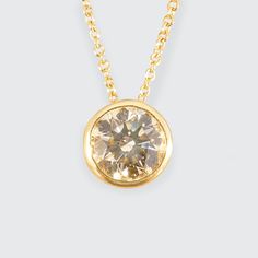 This exquisite bezel set Champagne Diamond necklace is a testament to sophistication and modern elegance, beautifully crafted in 18ct yellow gold. The centrepiece features a radiant 0.80ct champagne brilliant cut diamond, celebrated for its deep, golden hues and mesmerising sparkle. Encased in a seamless bezel setting, the diamond is perfectly framed by the rich yellow gold, enhancing its warm tones and brilliant radiance. This pendant is suspended on an fine 18"(with 16&17" options) 18ct yellow Gold Solitaire Necklace With Brilliant Cut For Formal Occasions, Modern Gold Diamond Necklace With Round Cut, Classic Gold Solitaire Necklace With Brilliant Cut, Luxury Gold Solitaire Necklace With Single Cut Diamonds, Luxury Gold Solitaire Necklace For Anniversary, Gold Solitaire Necklace With Tension Setting For Formal Occasions, Classic Yellow Gold Solitaire Necklace With Tension Setting, Gold Solitaire Diamond Necklace With Tension Setting, Classic Gold Diamond Necklace With Single Diamond