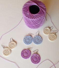 crochet earrings and yarn on a table