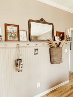 there are pictures on the wall and a basket in front of it, along with other items