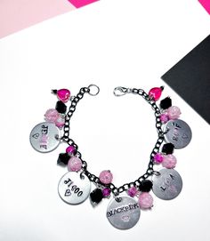 Blackpink bracelets with all the girl's stamped names, I colored their names with black and pink lettering. The bracelet has black and pink beads with cracked glass, pink marbled beads, and black crystals. I used black chain and hearts to represent their light sticks. The middle says Blackpink with a crown stamp. Show off your ultimates with this Blackpink bracelet, it is a must have for all Blinks. Due to the handmade nature of this product, there may be slight variations in charms and beads de Black Pink Bracelet, Blackpink Bracelet, Blackpink Jewelry, Blackpink Merch, Pandora Black, Blackpink Blink, Black Chain, Pink Beads, Pink Bracelet