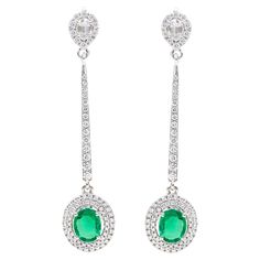 18 Karat White Gold Natural Emerald and Diamond Cluster Dangle Earrings This sensational shamrock green emerald and diamond long earring is a beautifully crafted pair. The rose cut diamond pear solitaire stud surrounded with the classic micro-pave diamond pear cluster is perfect for the long earring design, giving it variety. The white gold loop attached to the stud linking to the graduating single row of round diamonds and hooking to the hanging emerald is phenomenally elongating the earring. The double-halo diamond cluster backing the lush green oval emeralds is intriguing and a genius design. It’s a fine workmanship long hanging earring made to perfection. Details of the piece: Gross Weight: 6.355 grams 18 Karat Gold: 5.853 grams Diamond: 1.19 carats Emerald: 1.32 carats Note: This piec Long Earring, Emerald Earrings, Hanging Earrings, Green Emerald, Rose Cut Diamond, Diamond Cluster, Emerald Diamond, Natural Emerald, Long Earrings