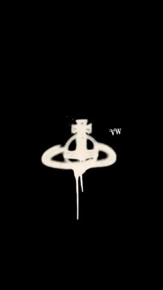 a black and white photo of a ring with the word w e on it, in front of a dark background