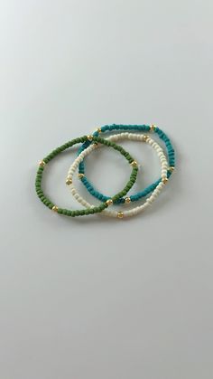 Handmade seed bead bracelet perfect for any occasion! Mini Beaded Bracelets, Green Heishi Beaded Colorful Friendship Bracelets, Green Heishi Beaded Bracelets With Colorful Beads, Green Heishi Beaded Bracelet With Letter Beads, Green Heishi Bead Bracelet With Letter Beads, Green Beaded Bracelet With Spacer Beads For Beach, Beach Green Beaded Bracelets With Spacer Beads, Casual Turquoise Beaded Bracelets With Tiny Beads, Colorful Heishi Beads Bracelets