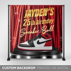 a birthday card featuring a pair of sneakers on top of a stage with red curtains