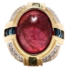 This stunning pink tourmaline and diamond gem-set cabochon cocktail ring is a one-of-a-kind piece. Crafted from 18K yellow gold, this unique cocktail ring features a large 22ctw pink tourmaline cabochon, which is encircled by a halo of sparkling diamonds. The ring is a size 6.5 and is sure to make a statement. This incredible piece is perfect for any special occasion, and would make an amazing addition to any jewelry collection. Stones: - pink tourmaline, 1 stone - oval cabochon - 18 x 14 x 10.6 mm - approximately 20.5 carats - diamonds, 68 stones - round brilliant cut - 1.5 mm - approximately 1 total carat - G-H color, VS-SI clarity - peridot - London blue topaz Ring Size 6.5 Rise Off Of Finger: 13 mm Length: 7/8 in. Weight: 12.5 dwts. / 19.5 grams Stamps: KM 18K 750 Ring Sizings & Modifi