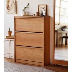 a wooden dresser sitting on top of a rug