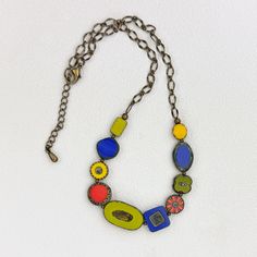 This  colorful necklace is casual and fun.  It is composed of various size, shape, and color Czech glass beads, alternated with antique brass round beads and attached to an antique brass chain.  All components are antique brass including the adjustable lobster clasp.  The necklace ranges 18 1/2" - 20 1/2" in length, and 5/8" wide at the widest point. Multicolor Brass Necklace With Round Beads, Multicolor Round Bead Brass Necklace, Multicolor Round Beads Brass Necklace, Vintage Multicolor Necklace With Adjustable Chain, Multicolor Czech Glass Necklace, Multi-strand Colorful Czech Glass Beaded Necklaces, Multicolor Multi-strand Czech Glass Beaded Necklaces, Multi-strand Czech Glass Beaded Necklace, Multicolor Czech Glass Beads, Single Strand