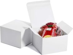 two white boxes with candy and candies in them