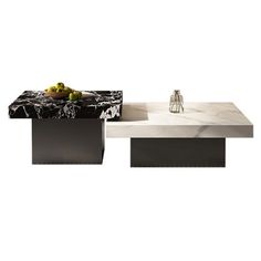 two tables with marble top and metal bases, one is black and the other is white