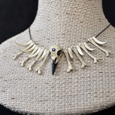 the necklace is made out of bone and has an animal's head on it