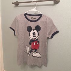 New With Tags. Disney Brand. Size L. Has Navy Trim On Collar And Sleeves Mickey Mouse Graphic Tee Tops, Mickey Mouse Themed Short Sleeve T-shirt, Themed Mickey Mouse Short Sleeve T-shirt, Fun Mickey Mouse Tops For Disney Fan Events, Themed Mickey Mouse Tops For Disney Events, Disney Mickey Mouse Crew Neck Top, Mickey Mouse Graphic Tee For Disney Trips, Disney Mickey Mouse Short Sleeve Top, Cotton Mickey Mouse Tops For Disney Trips