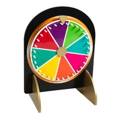 a colorful clock sitting on top of a wooden stand