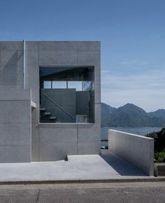 a concrete building with stairs leading up to the roof and windows on top of it