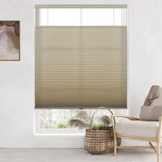 a living room with a chair, window and blinds in shades that are light brown