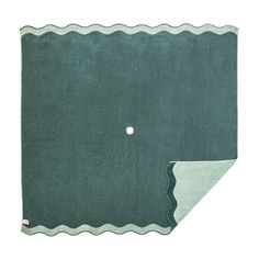 an image of a green rug with waves on the bottom and a white dot in the middle