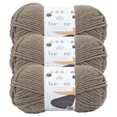 three skeins of yarn with the words, blue me on each end and one ball