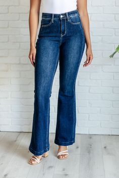 Experience unparalleled comfort and style with our Mavis High Rise Side Seam Detail Flare Jeans from Judy Blue. These high waisted, non-distressed jeans feature a dark wash and unique offset side seam detail for a flattering fit. The trouser style hem adds a touch of sophistication to any outfit. Elevate your denim game today! Judy Blue High Rise Zip Fly Dark Wash 4-Way Stretch Offset Side Seam Detail Flared Silhouette 93% Cotton, 6% Polyester, 1% Spandex True to Judy Blue Sizing 0/24: Waist 25" Judy Blue Jeans, Trouser Style, Short Leggings, Romper Dress, Cardigan Jacket, Dress Romper, Distressed Jeans, Flare Jeans, Jumpsuit Dress