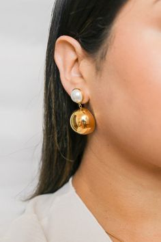 Elevate your style with our Charlotte Pearl Dome Earrings. These bold earrings feature a stunning Pearl Hemisphere design, adding a touch of luxe to any outfit. Make a statement with these elegant earrings that are perfect for both casual and formal occasions. All of our jewelry comes with a free jewelry pouch and cloth to keep your pretties safe and clean. Details Color: PVD 18K GoldMaterial: Stainless SteelSize: 4.17cm Care Guide Store in a dry, cool place away from sunlight i.e. Blush & Bliss Chic Evening Clip-on Earrings, Chic Formal Metal Clip-on Earrings, Trendy Round Earrings For Wedding, Trendy Round Wedding Earrings, Chic Formal Plug Earrings, Elegant Metal Linear Earrings For Formal Occasions, Chic Clip-on Earrings For Party, Party Linear Earrings With Plating, Chic Clip-on Drop Earrings