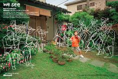 a young boy standing in front of a yard full of cut out people and plants