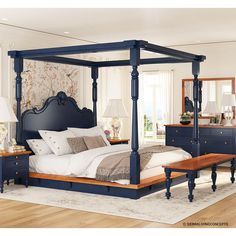 a bedroom with a four poster bed and blue dressers