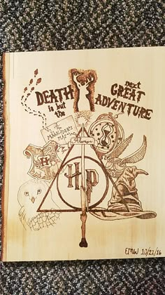 a wooden book with an image of the deathly great adventure on it's cover