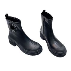 a pair of black boots with zippers on the side and one has a round hole in