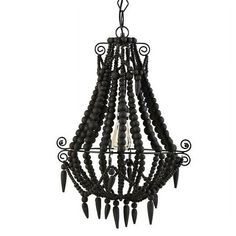 a chandelier with black beads and spikes hanging from it's center pole